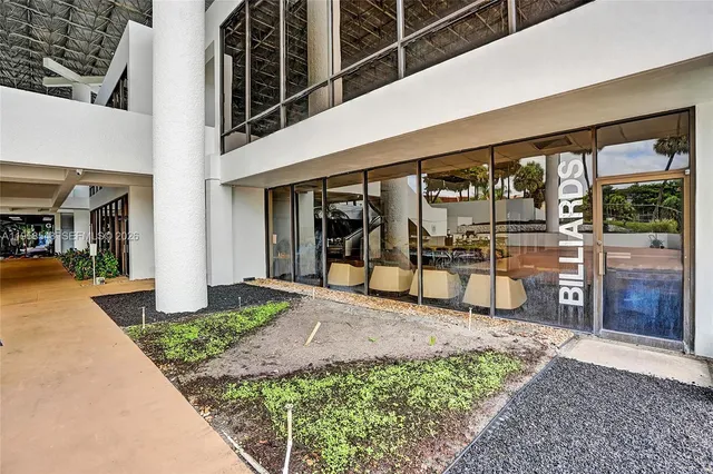 a view of a porch with a table and chairs