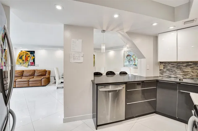 a kitchen with kitchen island cabinets and stainless steel appliances
