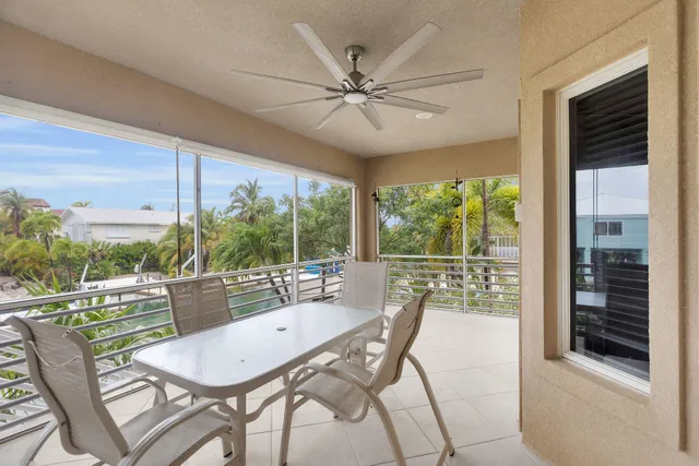 a dining room with furniture and a large window