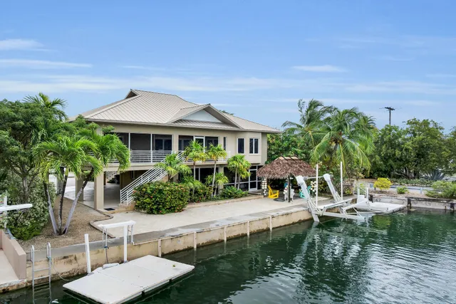 an aerial view of a house with swimming pool garden and patio