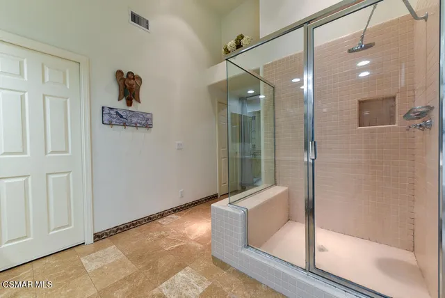 a bathroom with a bathtub and a shower