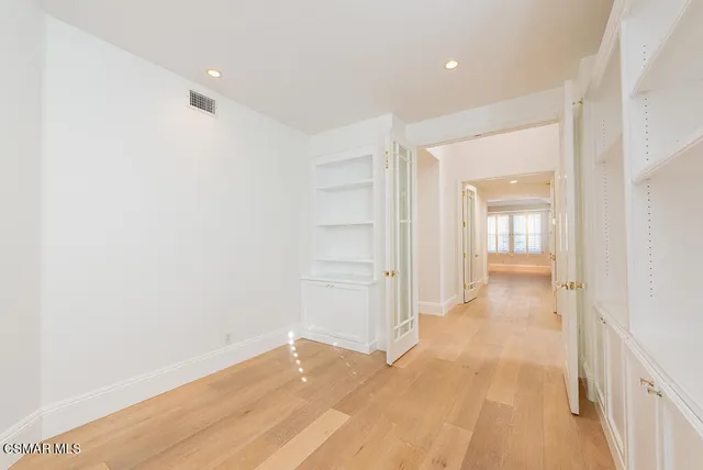 a view of a hallway with wooden floor
