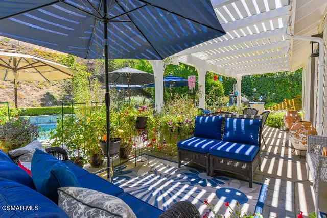 a view of a couches in patio with a yard