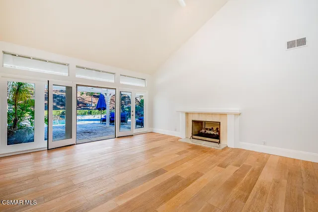 wooden floor in a room with a fireplace