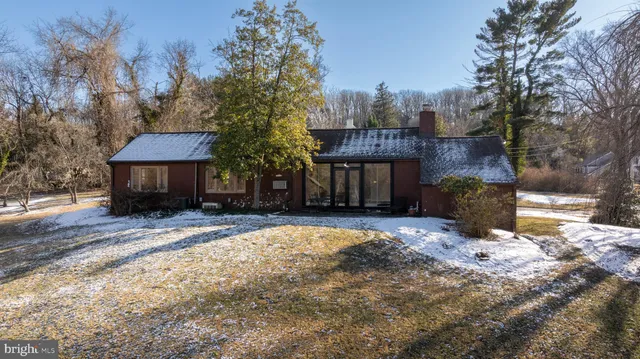 a view of a parking space with wooden fence