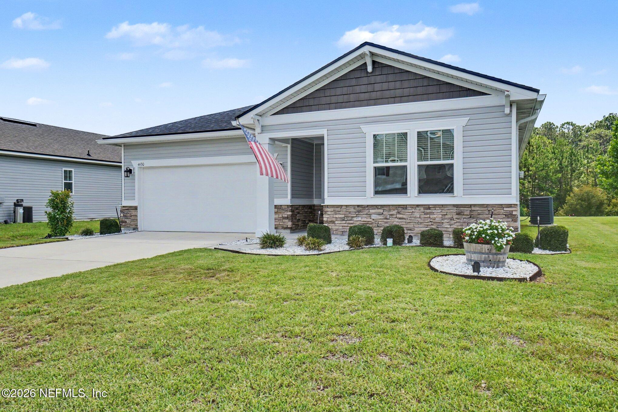 4630 Pine Ridge Parkway Middleburg, FL 32068 - Photo 2 of 35 a front view of a house with a yard and garage