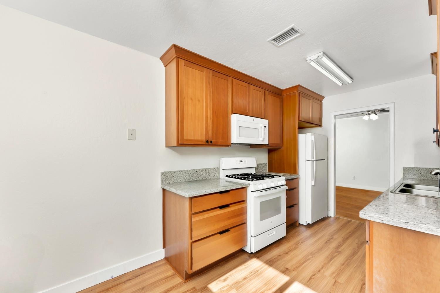 3620 Sean Drive Sacramento, CA 95821 - Photo 12 of 23 a kitchen with a stove a sink and a refrigerator
