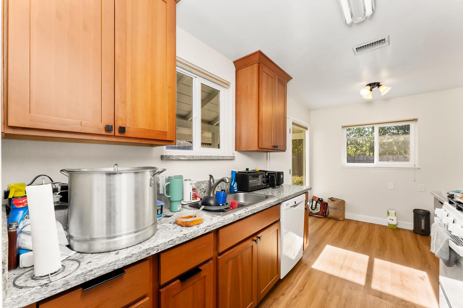 3620 Sean Drive Sacramento, CA 95821 - Photo 9 of 23 a kitchen with stainless steel appliances granite countertop a sink dishwasher stove and cabinets with wooden floor