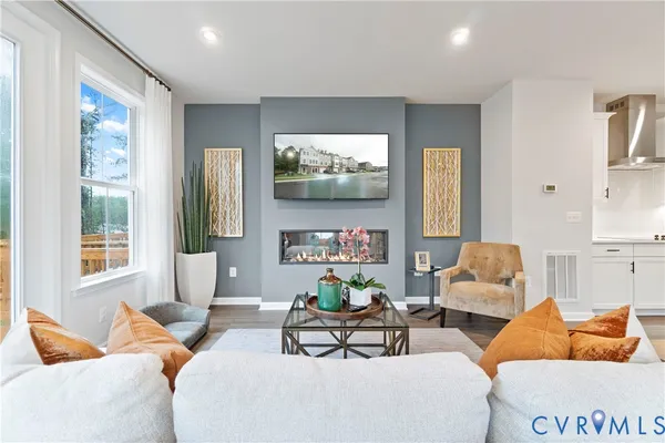 a living room with furniture a large window and a flat screen tv