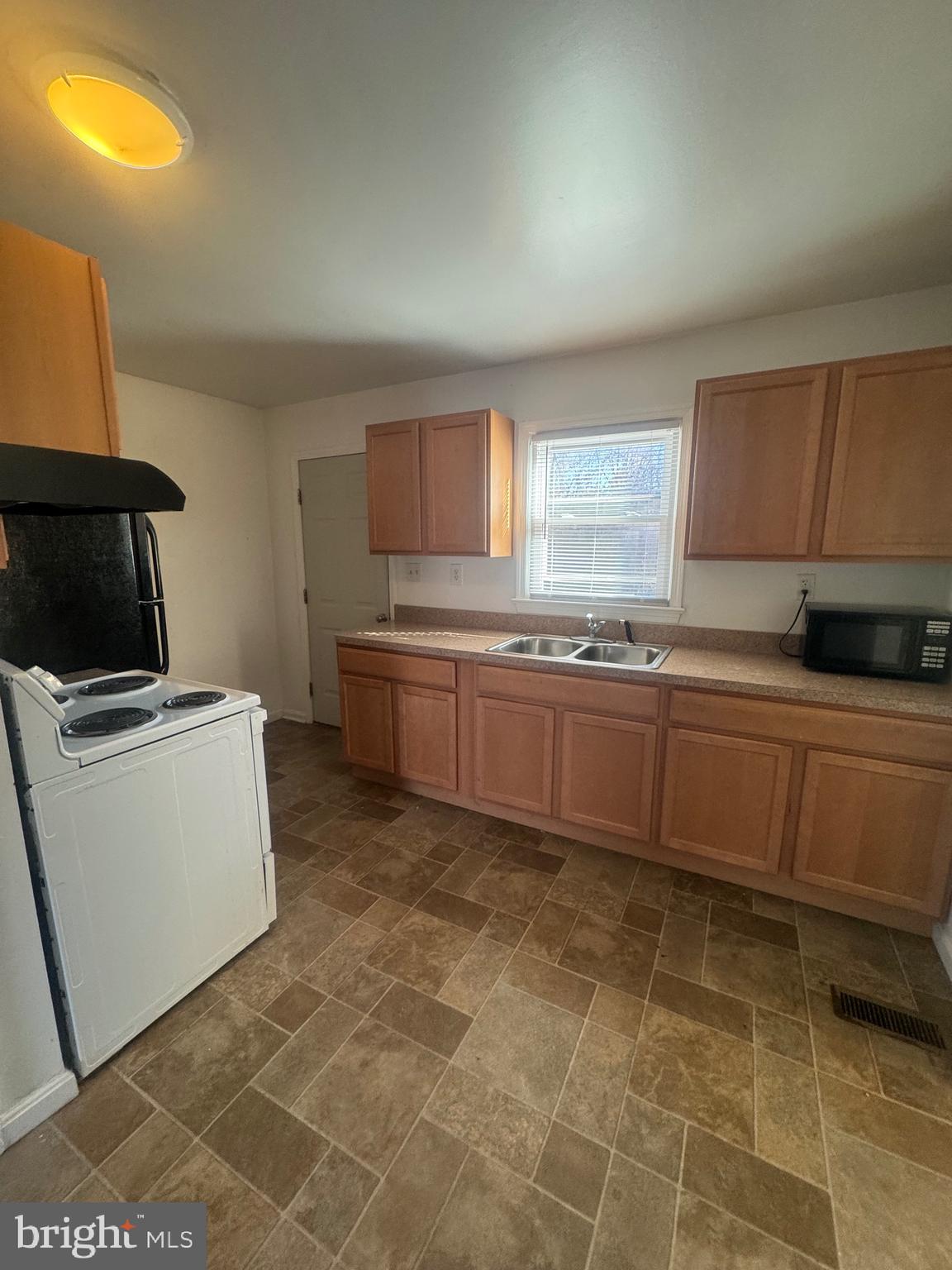 11370 Ridge Road King George, VA 22485 - Photo 6 of 17 a kitchen with a sink a stove cabinets and a window