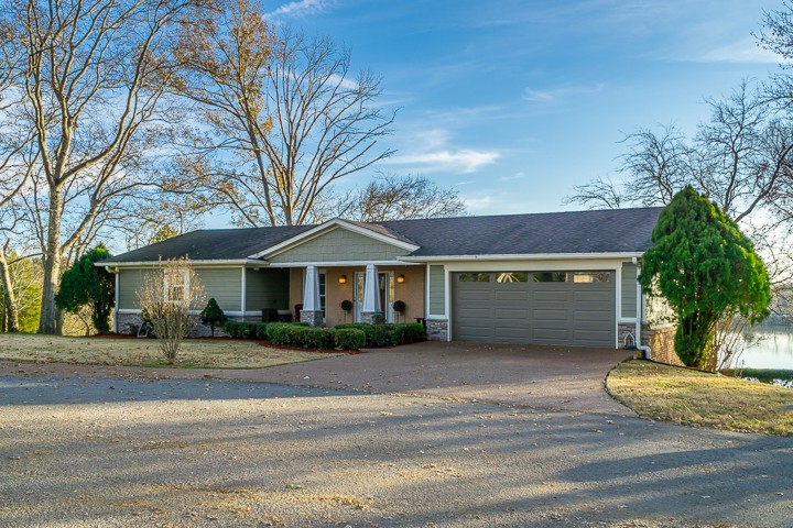 812 Burton Point Road Mount Juliet, TN 37122 - Photo 9 of 29 a front view of a house with a yard and garage