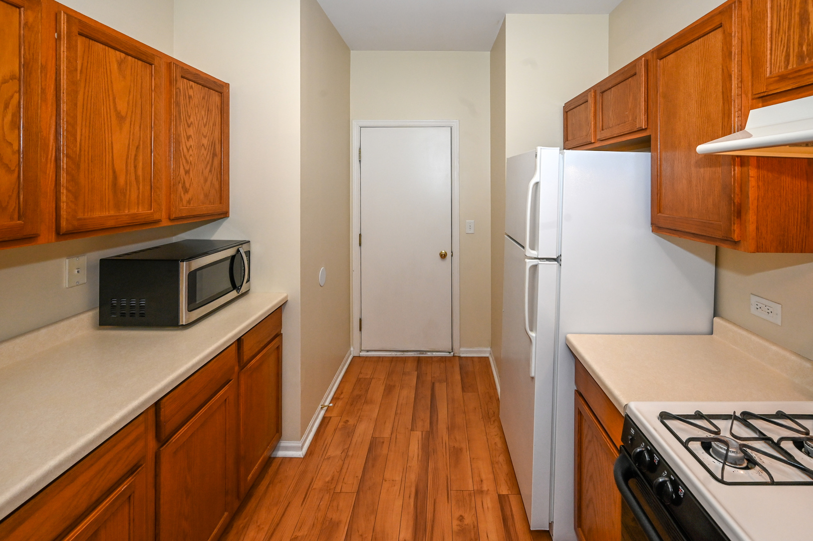 573 Telluride Drive Gilberts, IL 60136 - Photo 6 of 24 a kitchen with wooden cabinets and a stove top oven