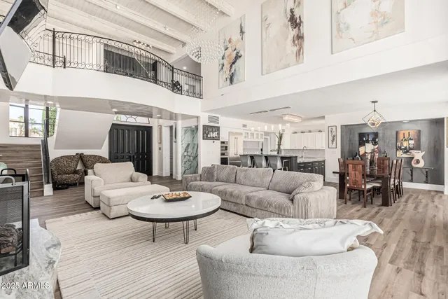 a kitchen with a sink dishwasher a refrigerator and white cabinets with wooden floor