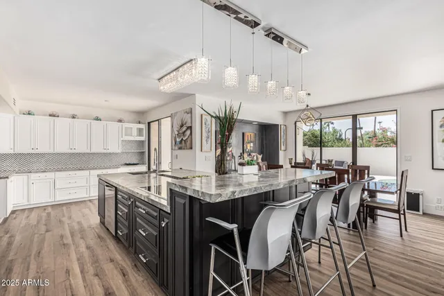 a view of a kitchen counter top space with stainless steel appliances granite countertop a sink and a window