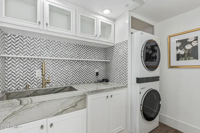 a spacious bathroom with a granite countertop sink mirror and shower