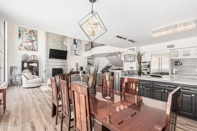 a view of a roof deck with table and chairs potted plants with wooden fence