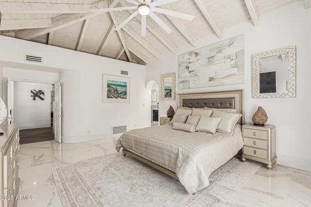 a bedroom with a bed and a large window