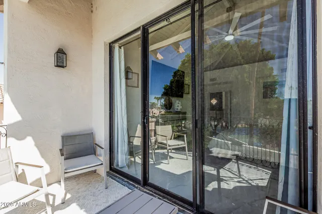 a view of a swimming pool with an outdoor seating and a forest