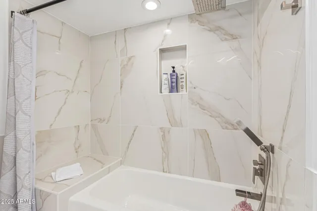 a view of a yard with plants and large trees