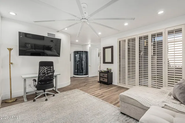 a view of a house with a yard and potted plants