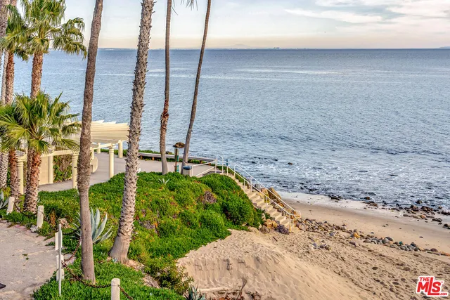 a living room with furniture a table and a fireplace
