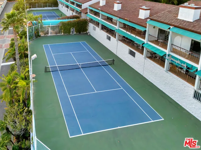 an aerial view of a house with a garden and lake view