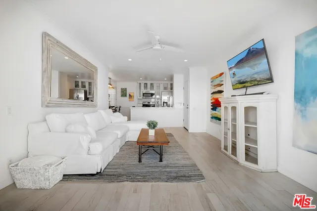 a kitchen with stainless steel appliances white cabinets and stove top oven