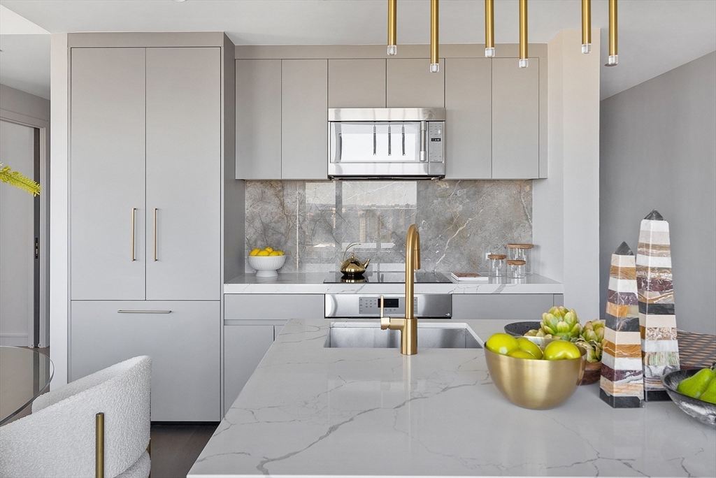 55 Lagrange Street, Unit 1804 Boston, MA 02116 - Photo 12 of 28 a kitchen with a white stove top oven and cabinets