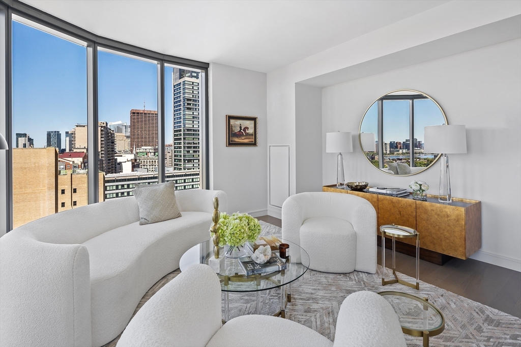 55 Lagrange Street, Unit 1804 Boston, MA 02116 - Photo 4 of 28 a living room with furniture flowerpot and a mirror
