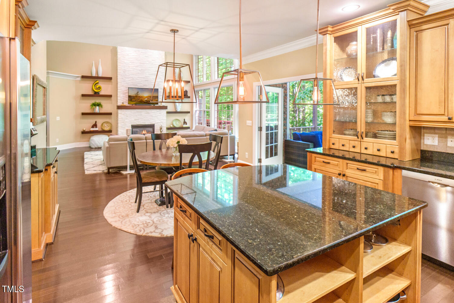 412 Bowen Road Rougemont, NC 27572 - Photo 24 of 40 a kitchen with stainless steel appliances granite countertop a table chairs in it and wooden floors