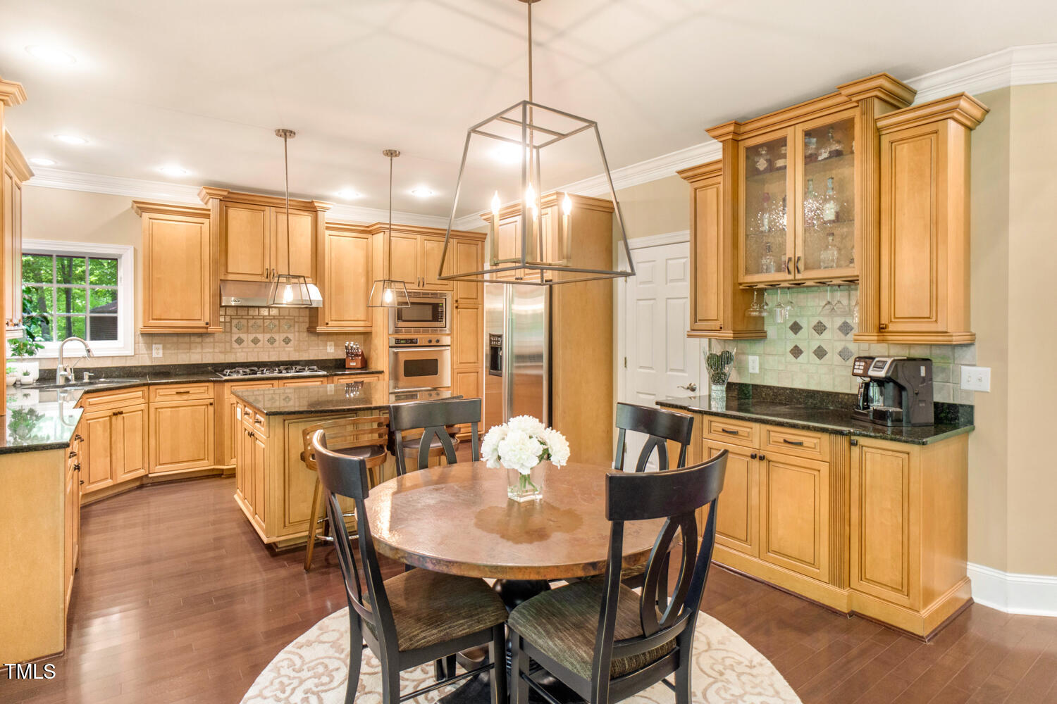 412 Bowen Road Rougemont, NC 27572 - Photo 29 of 40 a kitchen with stainless steel appliances granite countertop a stove a sink a refrigerator a dining table and chairs