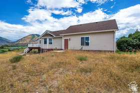 19 East Southfield Road Spanish Fork, UT 84660 - Photo 66 of 74 View of front of house with a deck with mountain view and stairs