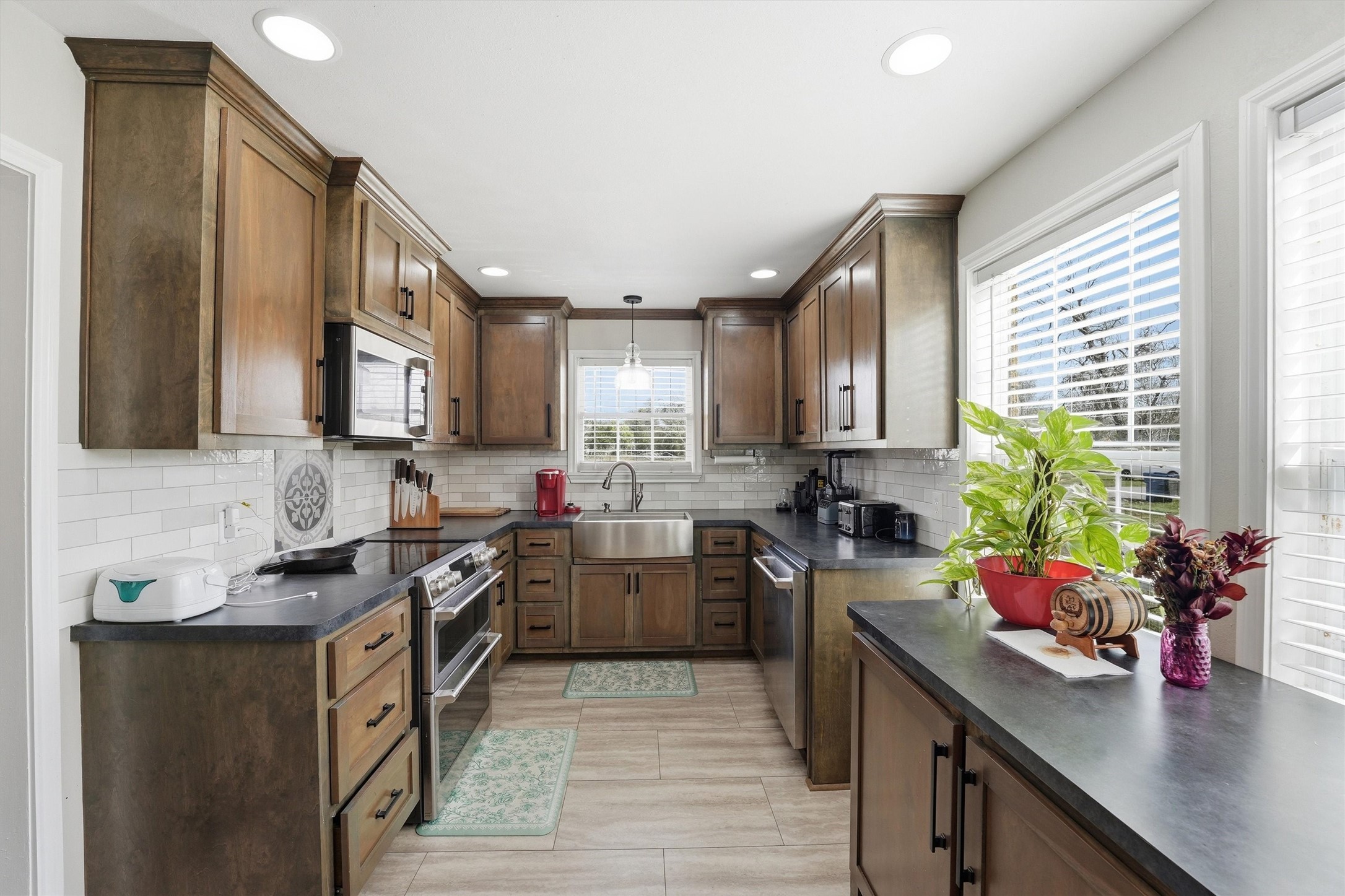 403 South Velasco Street Angleton, TX 77515 - Photo 12 of 25 a kitchen with a sink stove top oven and cabinets