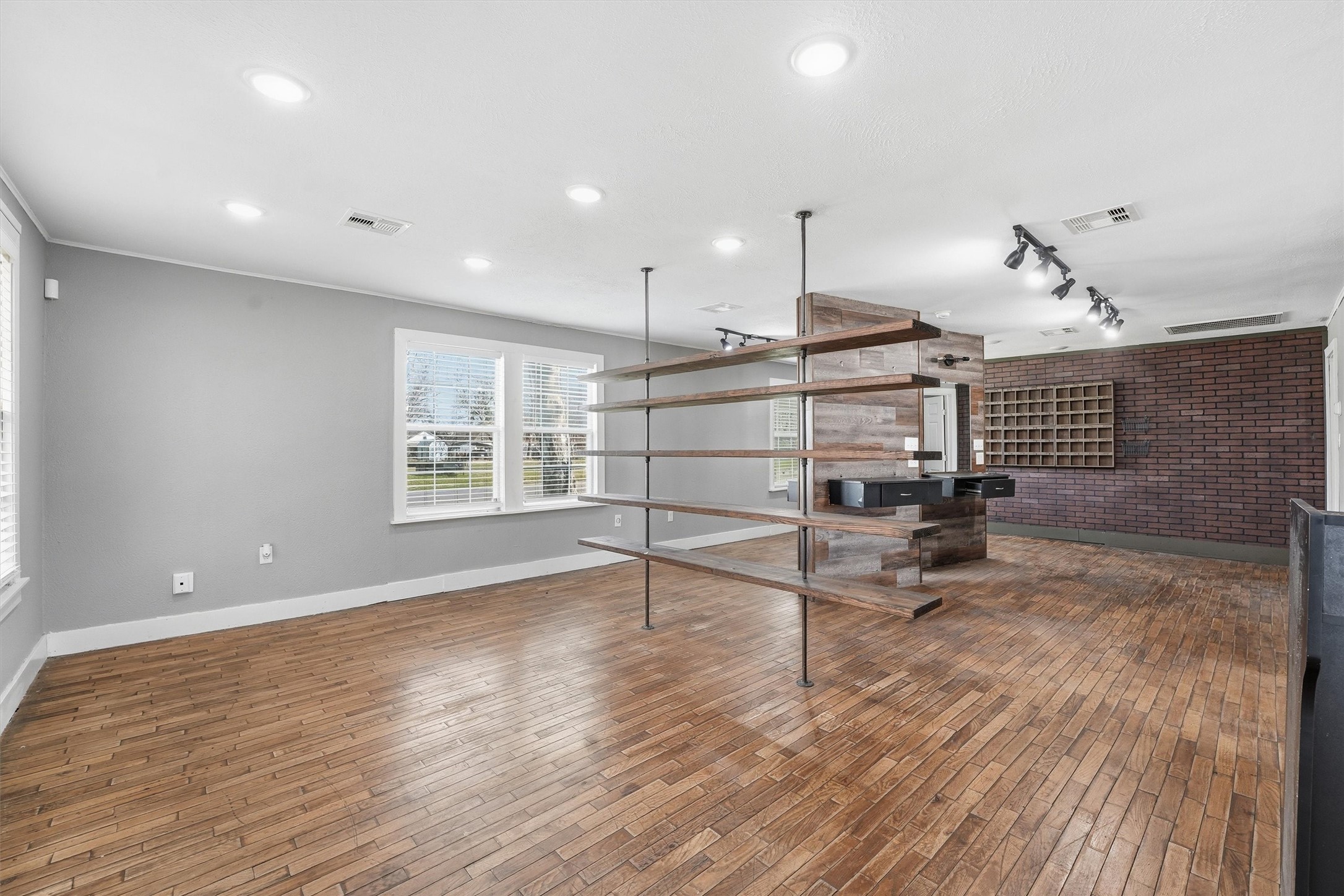 403 South Velasco Street Angleton, TX 77515 - Photo 16 of 25 a view of wooden floor and windows in a room