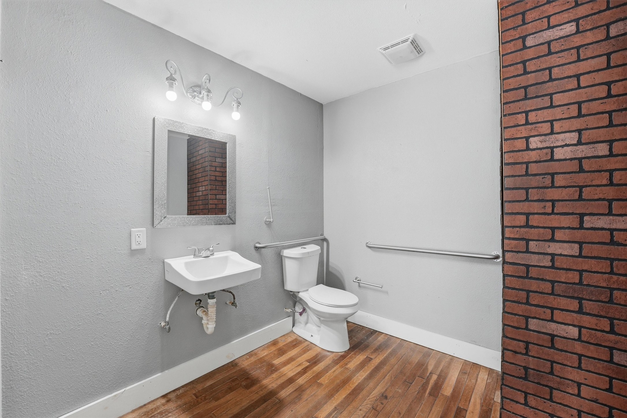 403 South Velasco Street Angleton, TX 77515 - Photo 20 of 25 a bathroom with a toilet and a sink