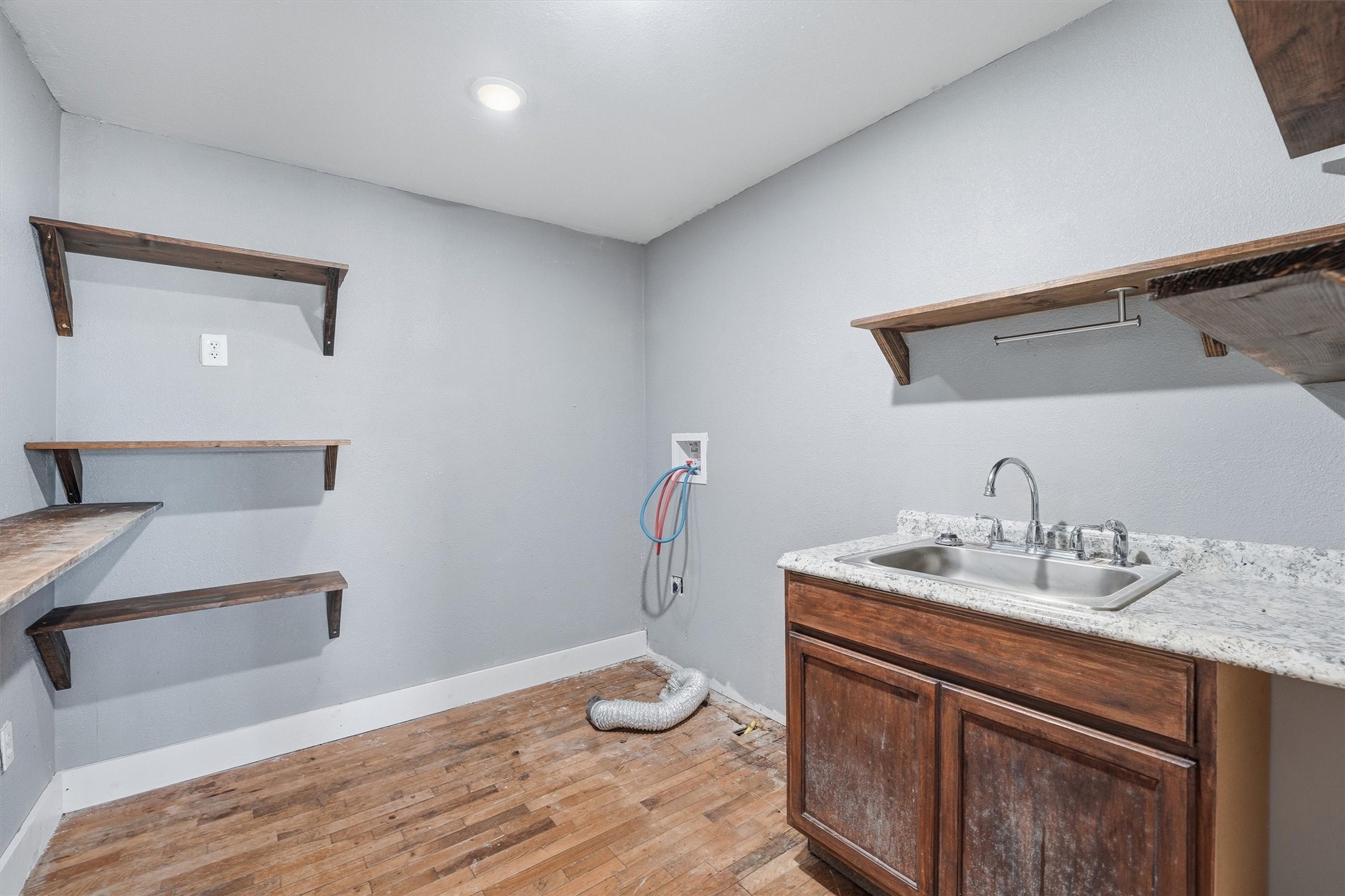 403 South Velasco Street Angleton, TX 77515 - Photo 21 of 25 a bathroom with a sink and a mirror