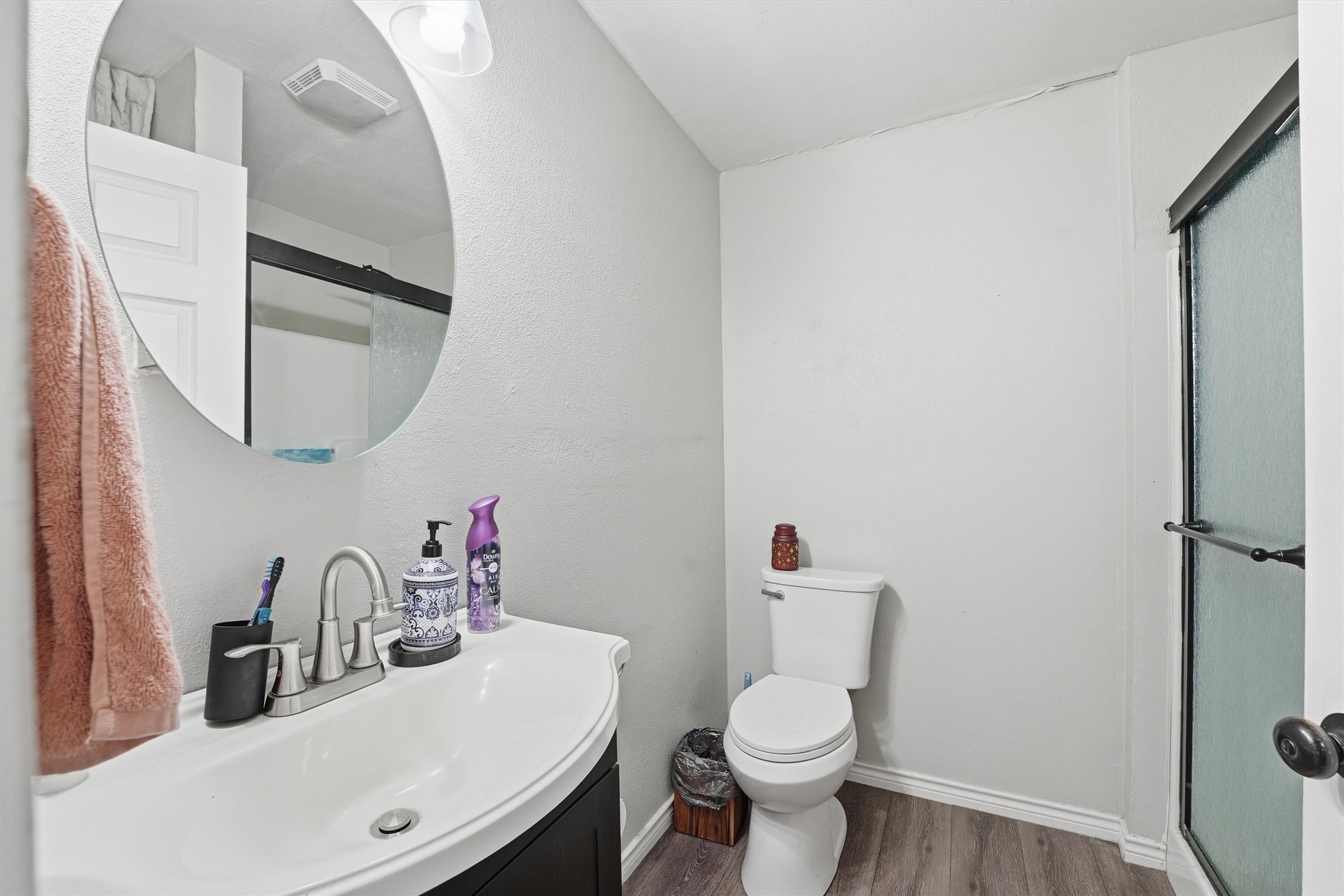 403 South Velasco Street Angleton, TX 77515 - Photo 7 of 25 a bathroom with a sink vanity mirror and toilet