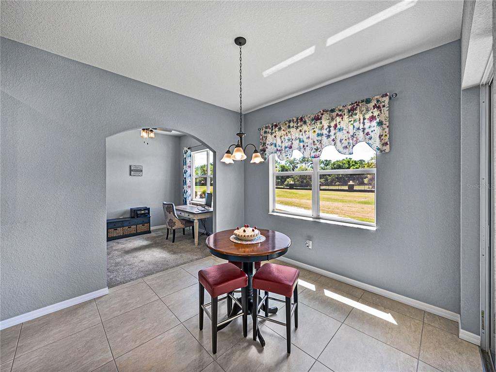 1124 Sawgrass Drive Winter Haven, FL 33859 - Photo 21 of 85 a view of a dining room with furniture window and outside view