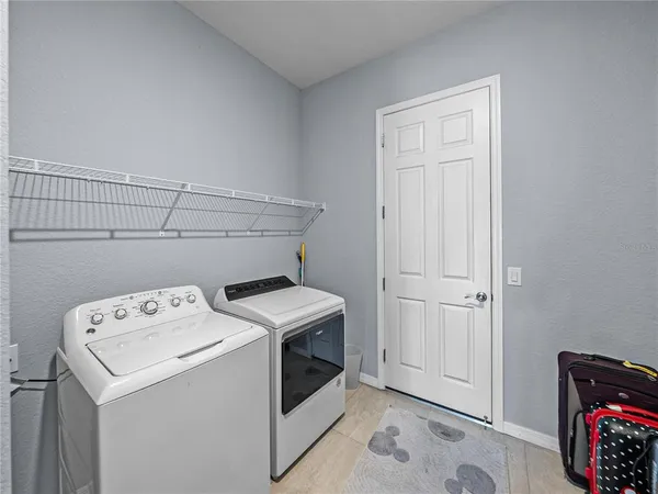 a bathroom with a granite countertop toilet sink and mirror