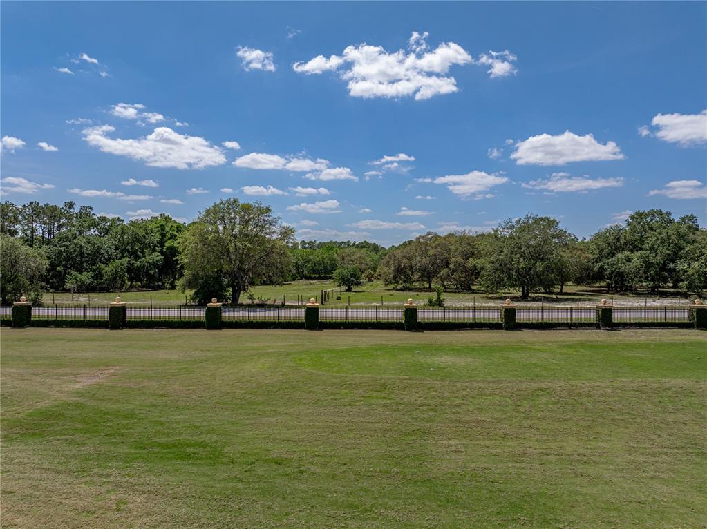 1124 Sawgrass Drive Winter Haven, FL 33859 - Photo 50 of 85 a view of a lake with a house in the background
