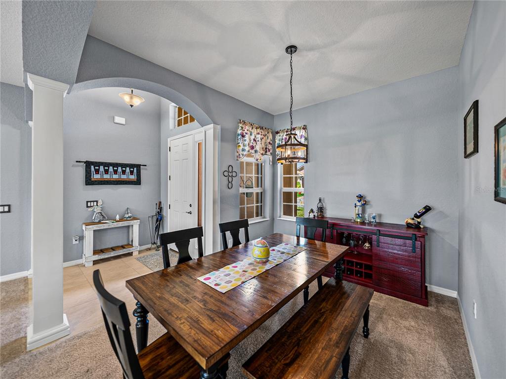 1124 Sawgrass Drive Winter Haven, FL 33859 - Photo 5 of 85 a view of a dining room with furniture window and wooden floor