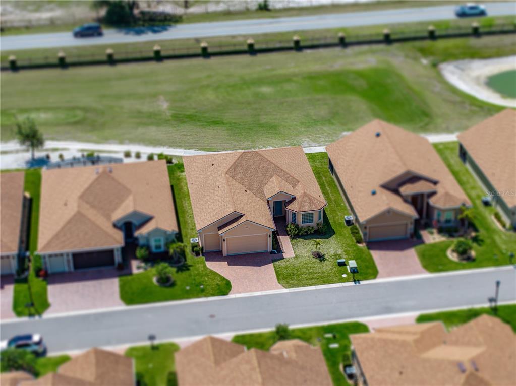 1124 Sawgrass Drive Winter Haven, FL 33859 - Photo 55 of 85 an aerial view of a house with a garden and lake view