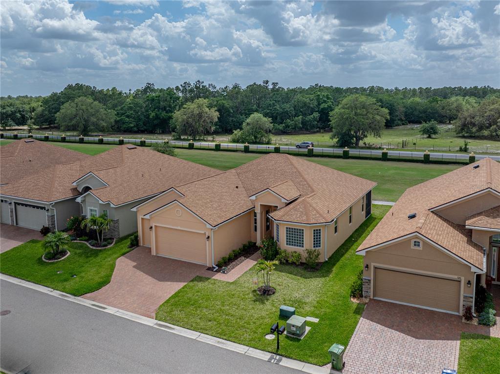 1124 Sawgrass Drive Winter Haven, FL 33859 - Photo 57 of 85 an aerial view of a house with a garden and a yard
