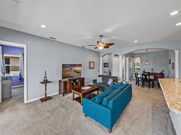 a living room with furniture and kitchen view