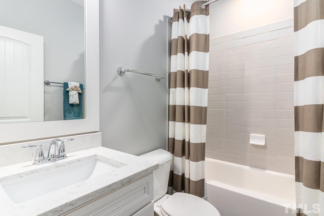 701 Virginia Avenue Raleigh, NC 27604 - Photo 11 of 16 a bathroom with a sink toilet vanity and shower