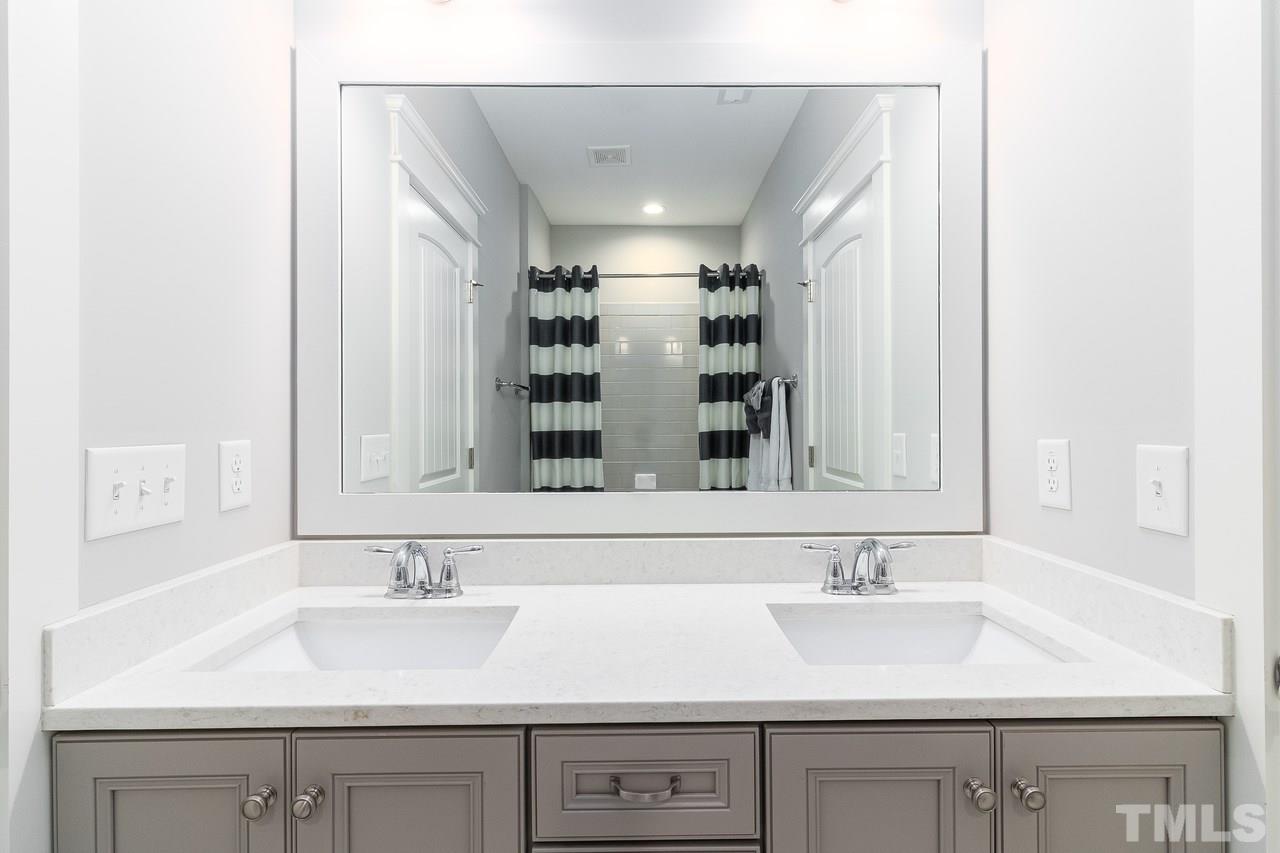 701 Virginia Avenue Raleigh, NC 27604 - Photo 12 of 16 a bathroom with a sink and a mirror