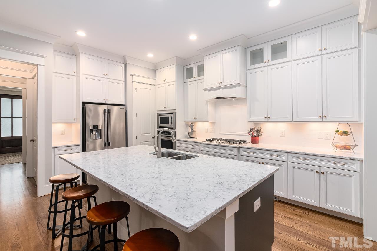 701 Virginia Avenue Raleigh, NC 27604 - Photo 3 of 16 a kitchen with stainless steel appliances granite countertop a kitchen island a stove a table and chairs
