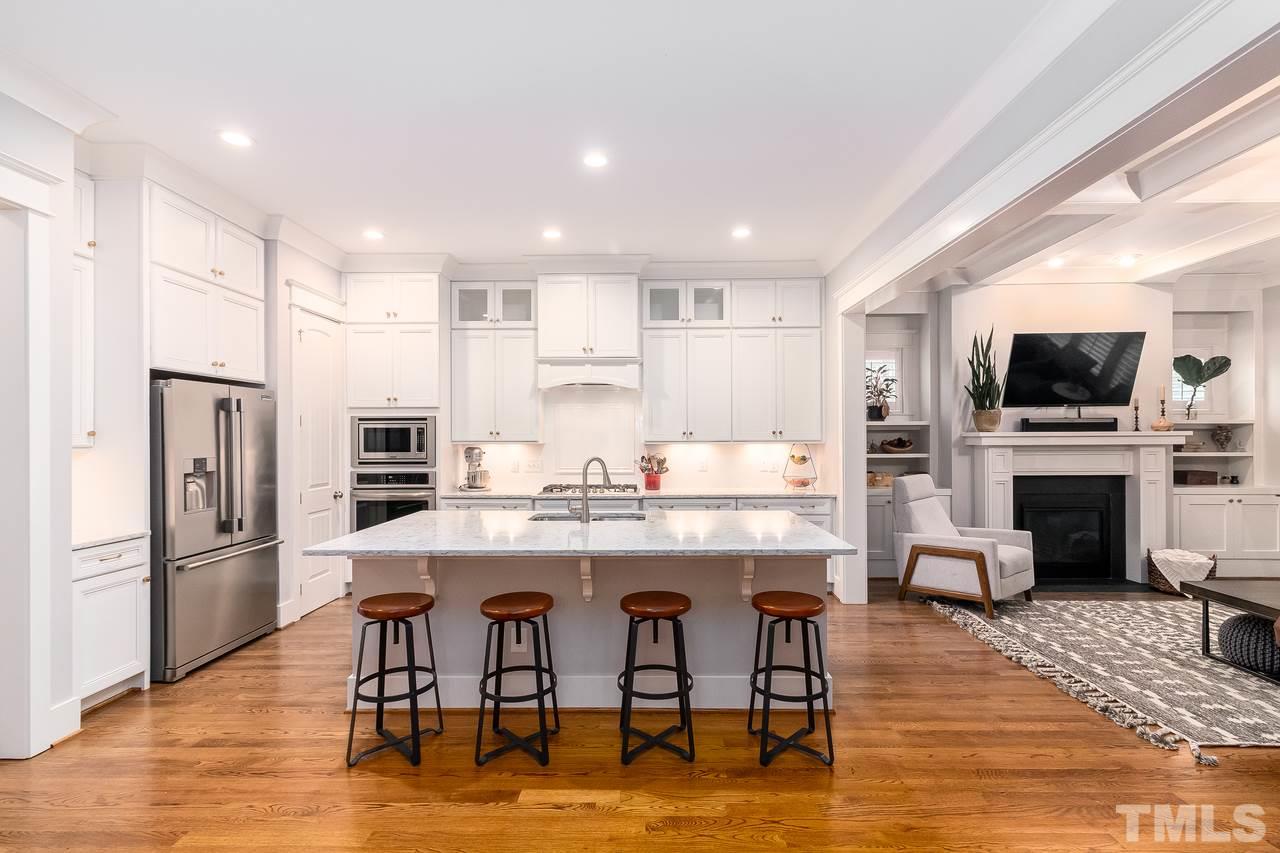 701 Virginia Avenue Raleigh, NC 27604 - Photo 16 of 16 a kitchen with stainless steel appliances a dining table chairs refrigerator and sink