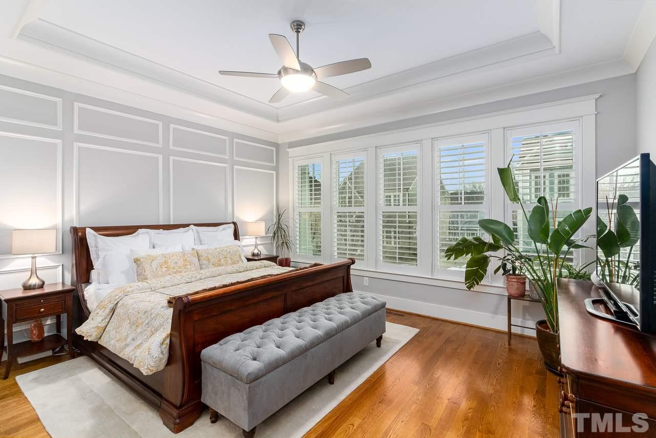701 Virginia Avenue Raleigh, NC 27604 - Photo 6 of 16 a spacious bedroom with a bed and a potted plant