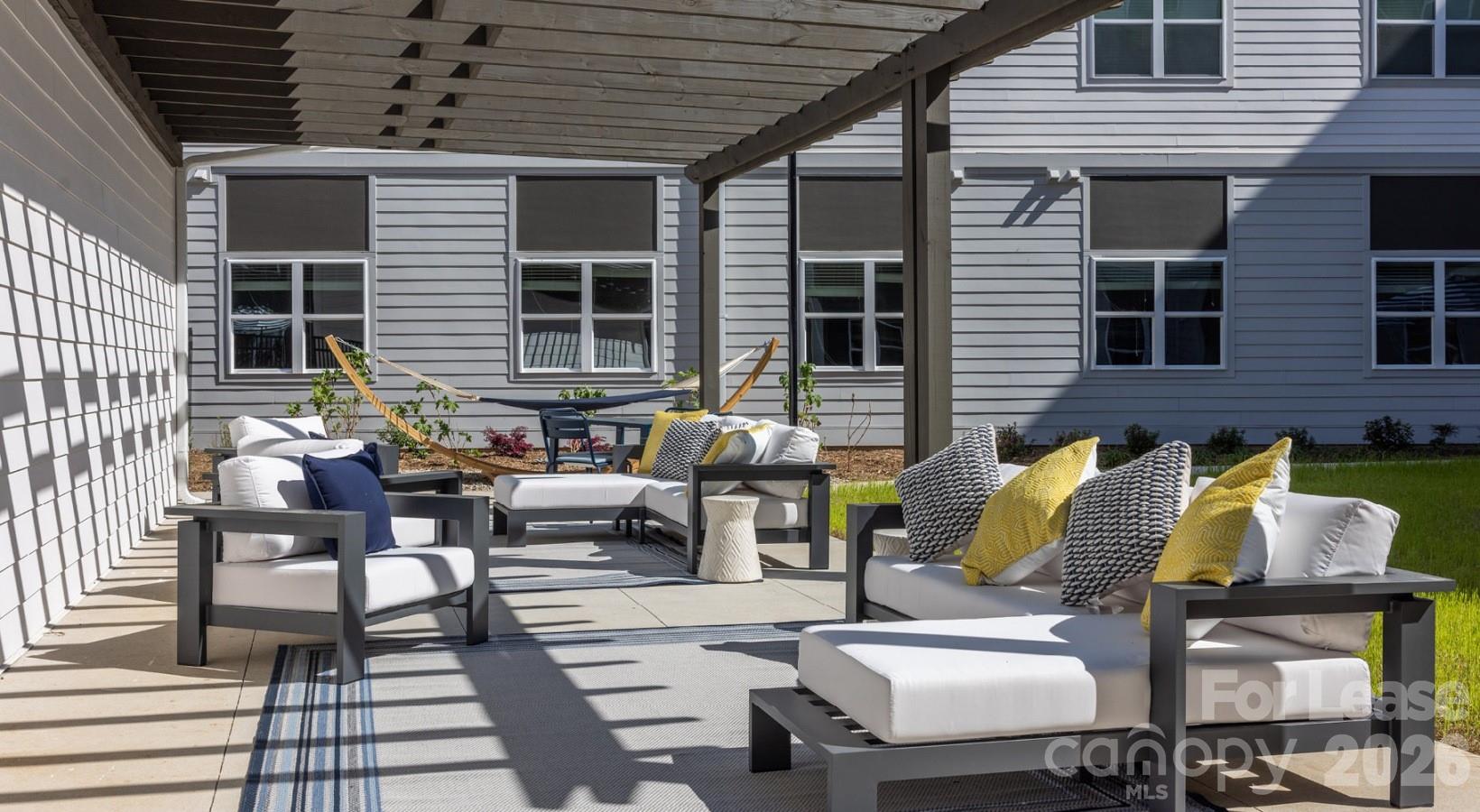 8424 North Tryon Street, Unit B2 Charlotte, NC 28262 - Photo 12 of 25 a view of a patio with couches and potted plants